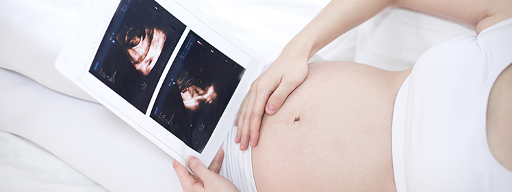 Pregnant woman during baby scan Swords clinic – early ultrasound imaging for reassurance and fetal development monitoring.